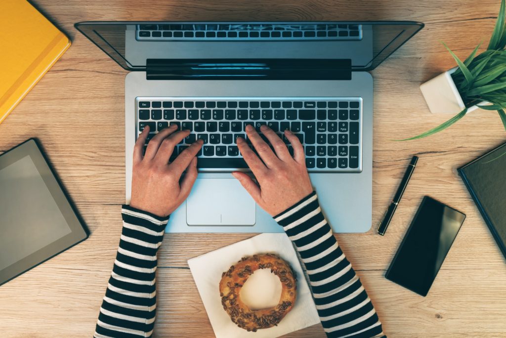 Office life, female hands working on laptop computer, top view